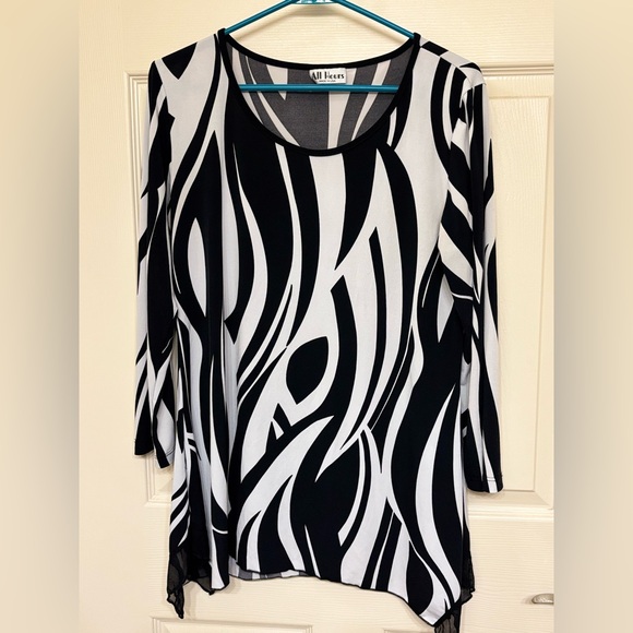 All Hours Tops - Zebra print shark bite hem top!